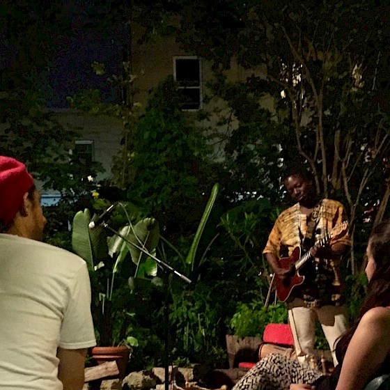That garden at night with West African music played by Koby